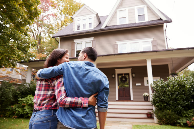 Rear,View,Of,Loving,Couple,Walking,Towards,House