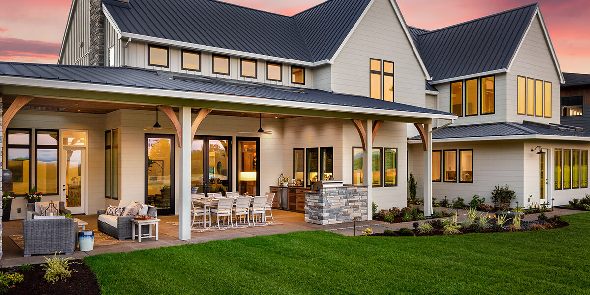 facade of home with manicured lawn and large covered patio