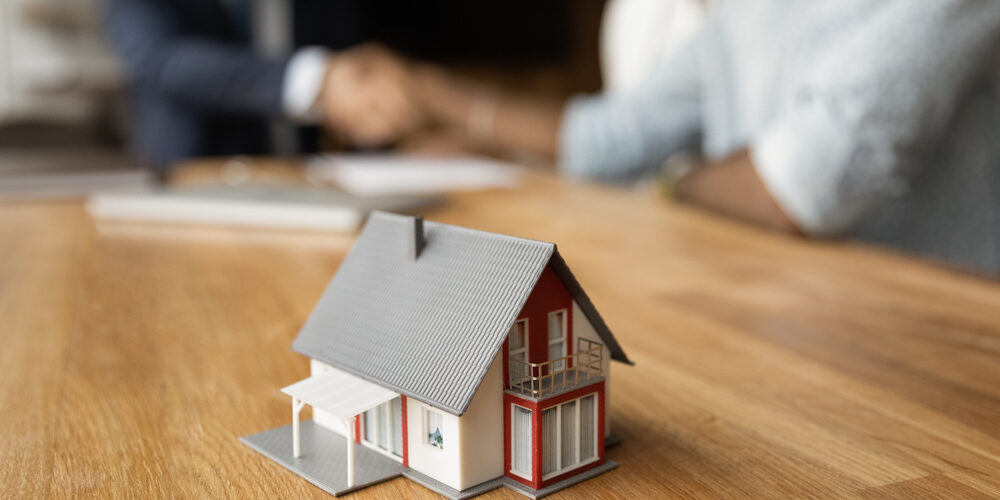 Miniature,Of,Cottage,House,On,Table,Close,Up,View,,Happy