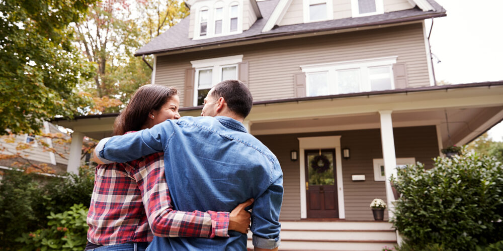 Rear,View,Of,Loving,Couple,Walking,Towards,House